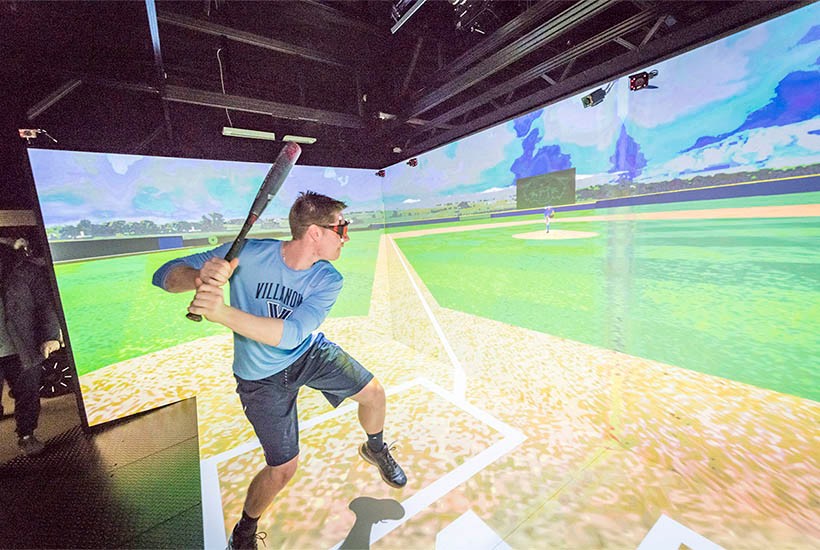 A student in a baseball simulator
