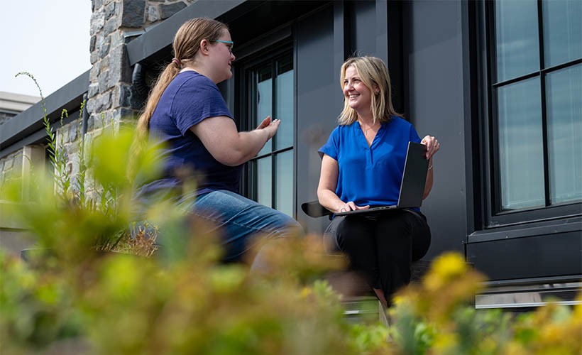 A professor talks with students in an outdoor lab.