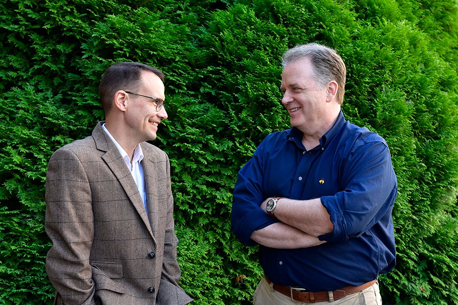 Two professors talking outside.