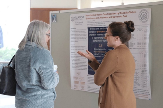 A woman giving a presentation to a bystander