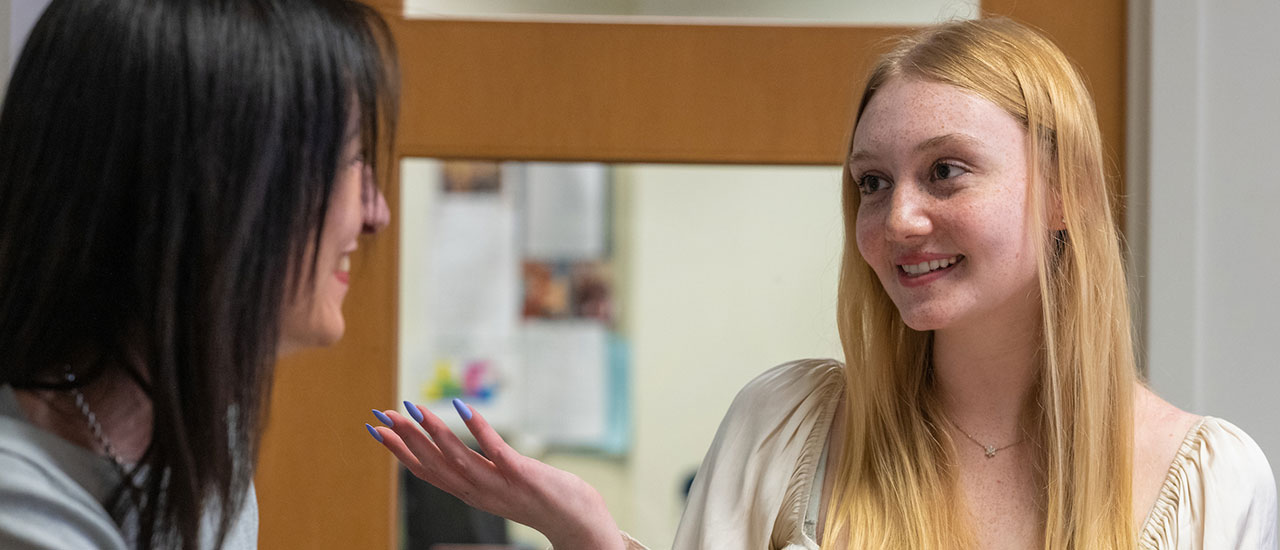 Professor and student sitting at table