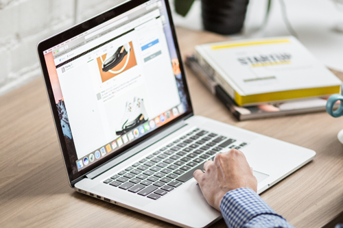 person writing on a laptop