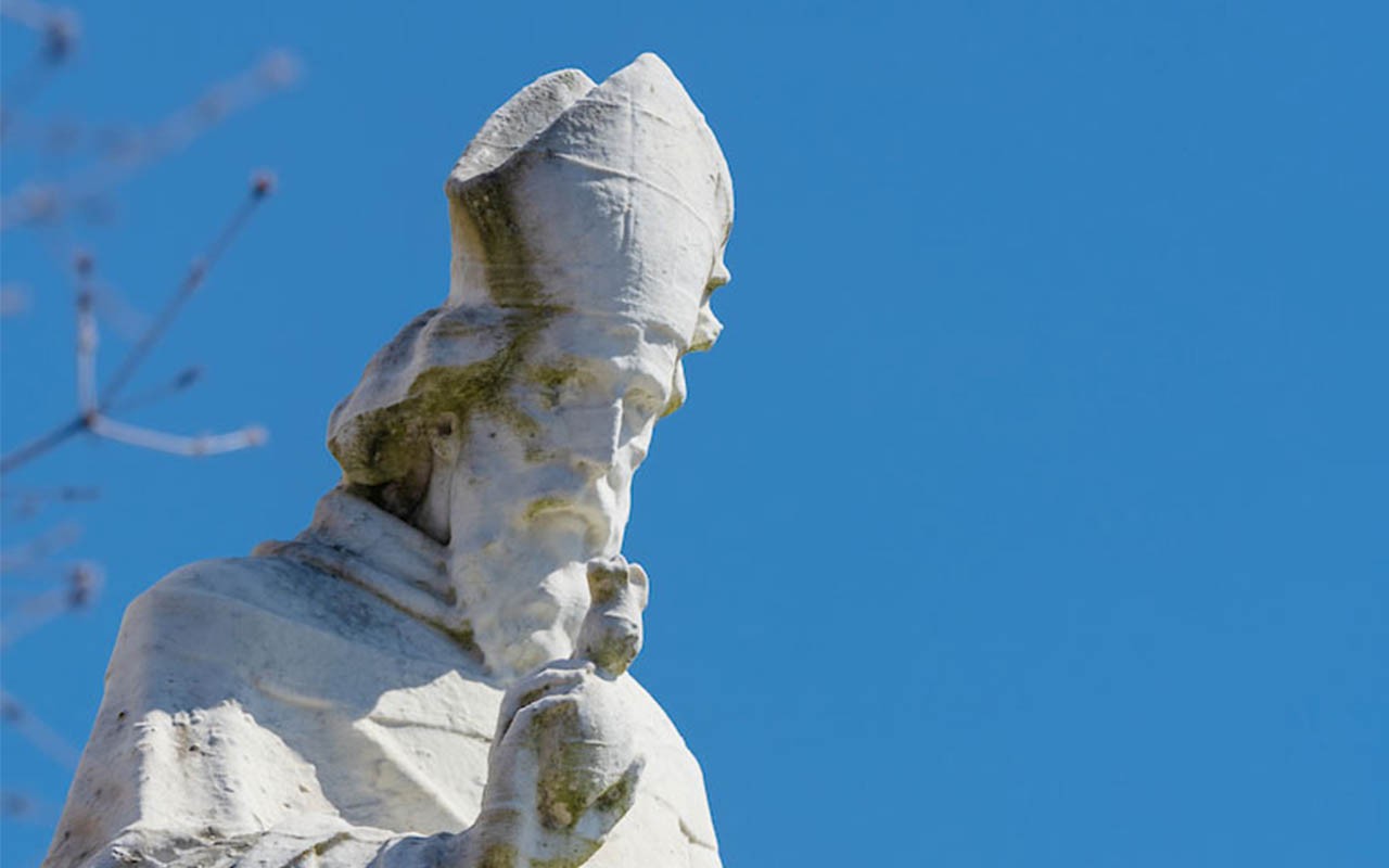 Image of St Augustine statue in front of Monastery