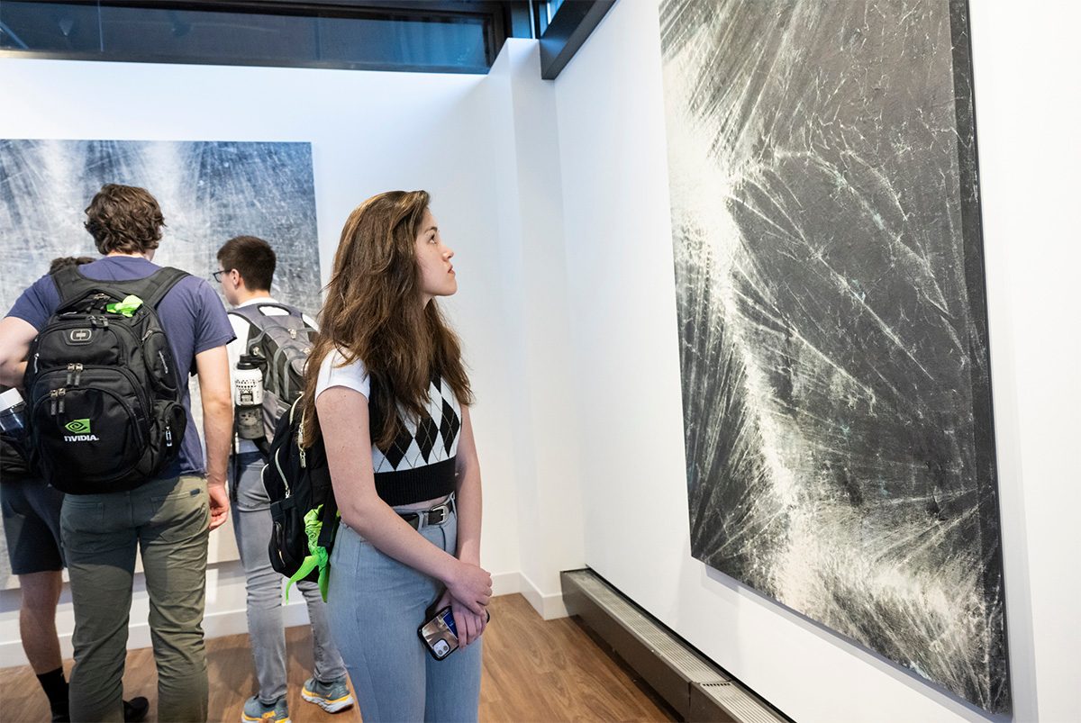 Female student looking at artwork